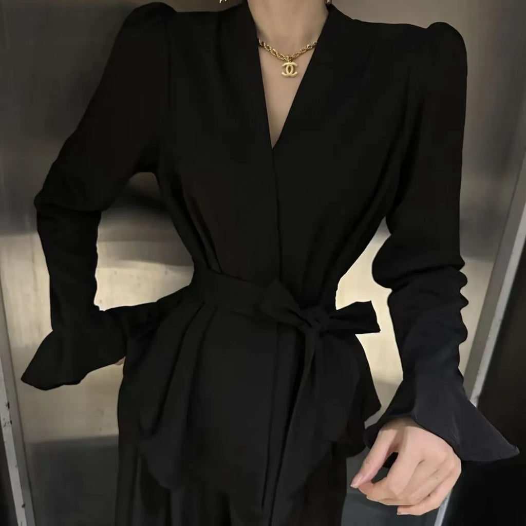 Women's black French-style shirt with irregular collar, tied front, and long flared bell sleeves