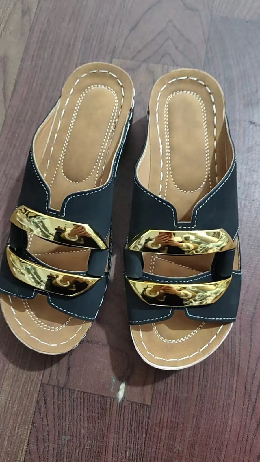 Roman style platform sandals in black with metal details and a rubber sole.