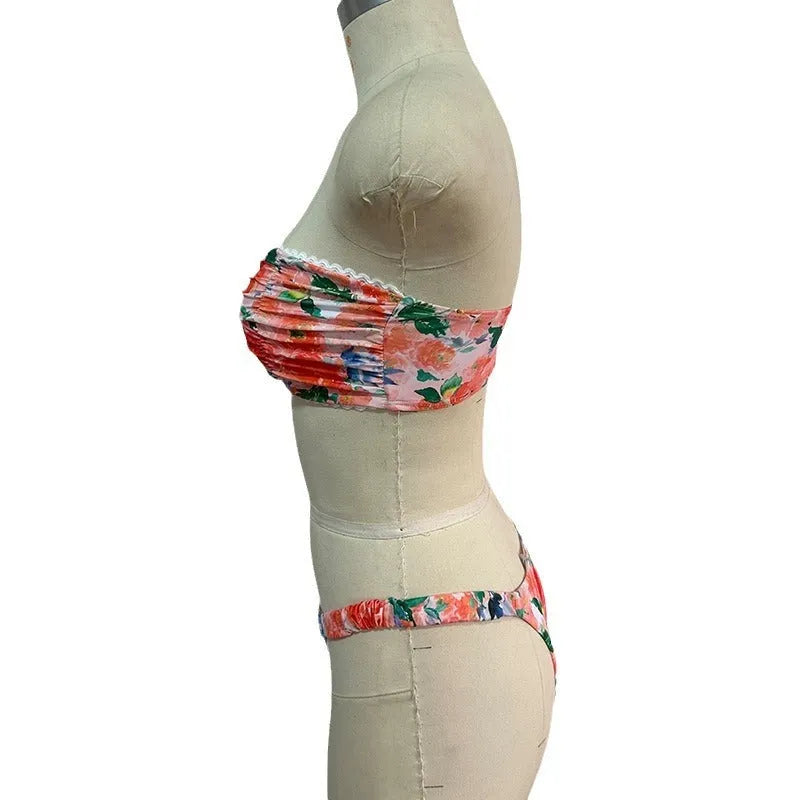 Women's floral print bikini set with lace trim on a backless tube top and matching briefs.