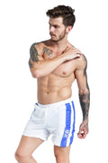 Man wearing blue slim-fit sports shorts with a lace-up front and padding.
