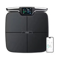 Black eight-electrode body fat and weighing scale on a floor.