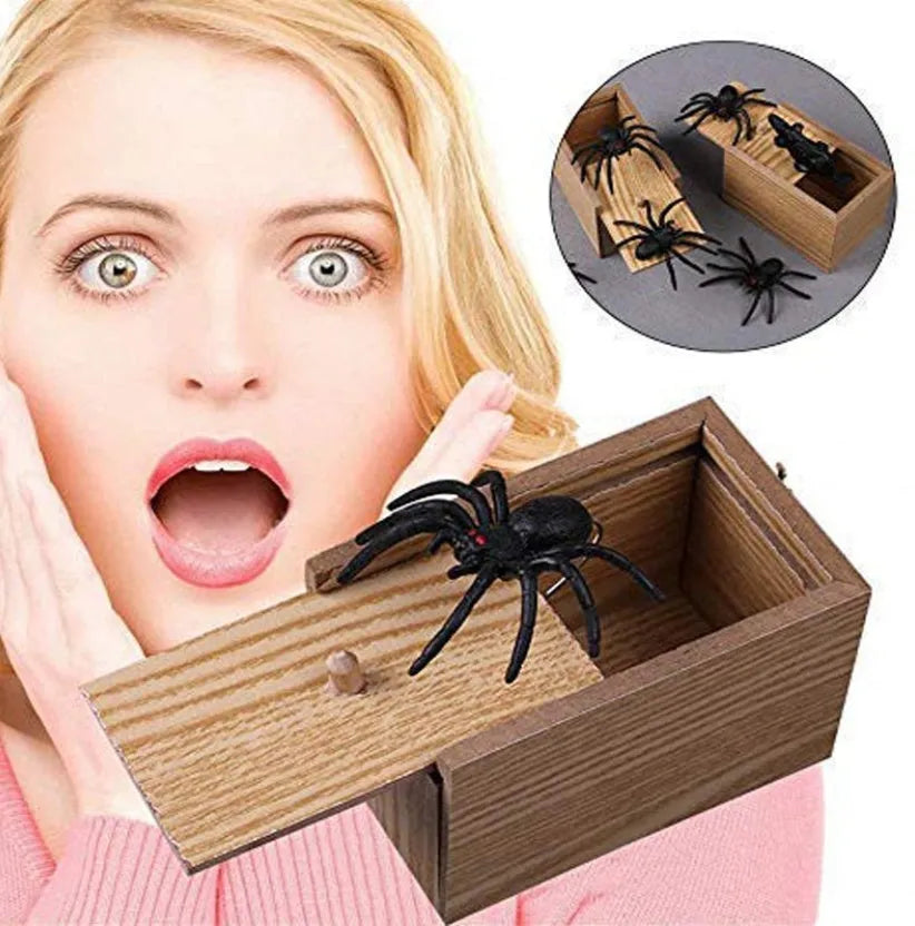 Wooden prank scare box with lid open showing a lifelike spider figurine on a spring.