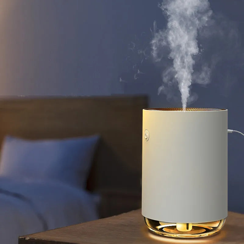 Green, pink, and white USB-powered humidifier diffuser with night light function on a wooden table.