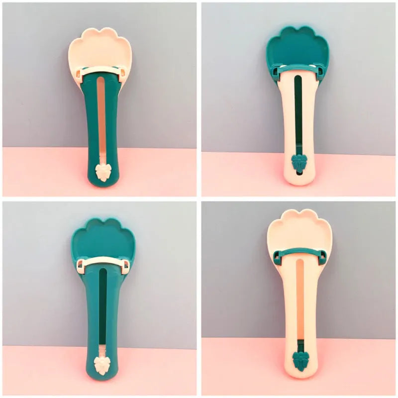 Green and pink silicone pet food spoon with squeezer function for dispensing treats and liquid food to cats and dogs