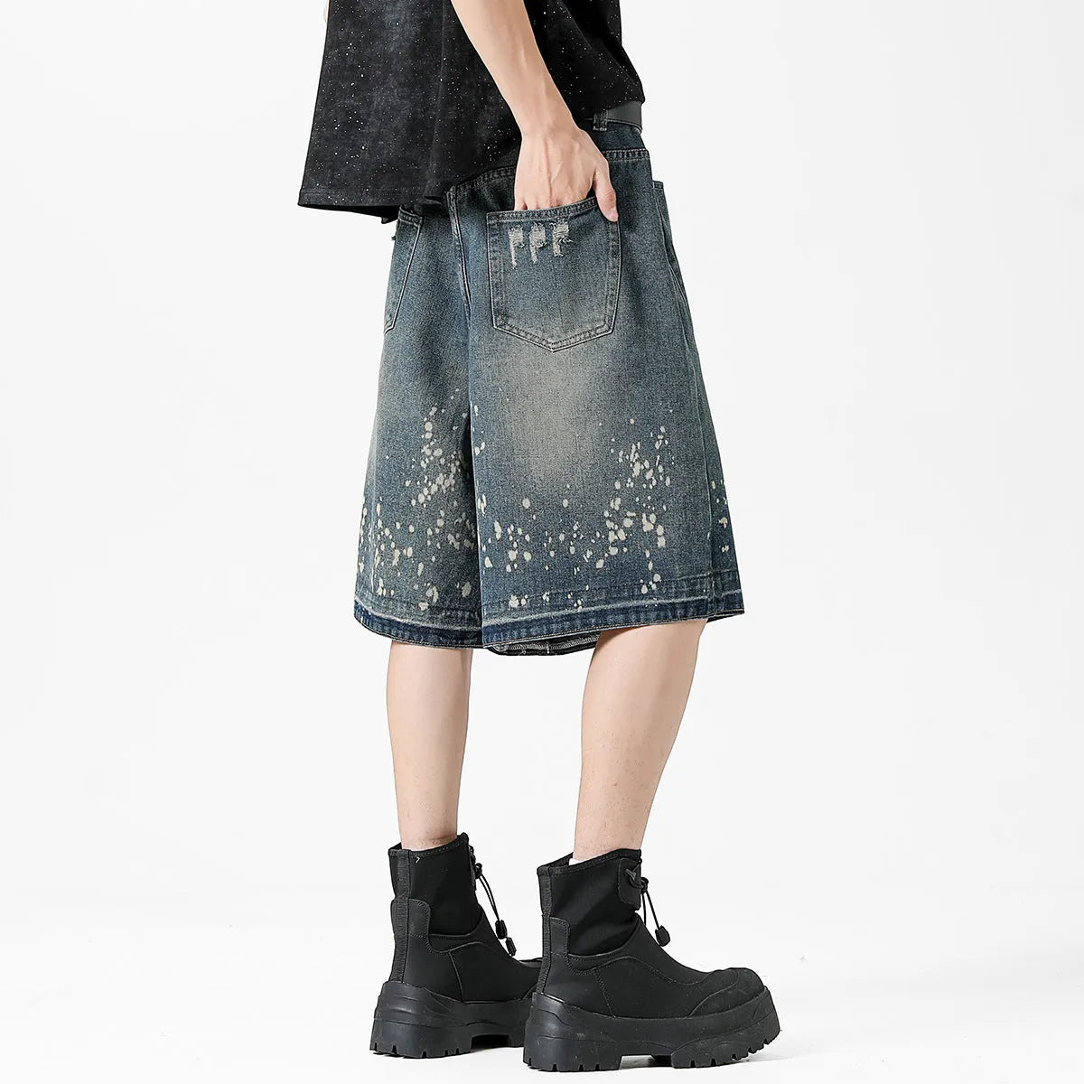 Men's retro blue denim shorts with ripped details, splash ink design, and five-point star decorations on a straight-leg cut.