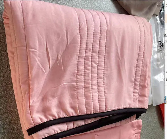 Pure colour seersucker cooling air-conditioning quilt laid flat on a bed