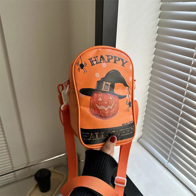 Black Halloween crossbody bag with graffiti print of cartoon pumpkins, ghosts, and bats.