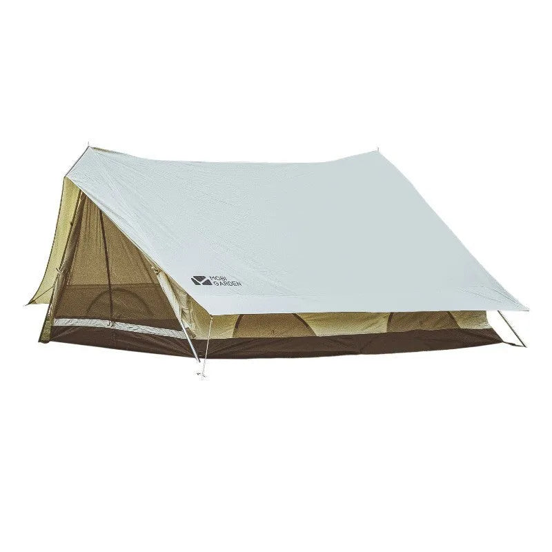 Large light luxury family camping tent in ivory white with cotton-polyester outer and aluminium poles set up outdoors