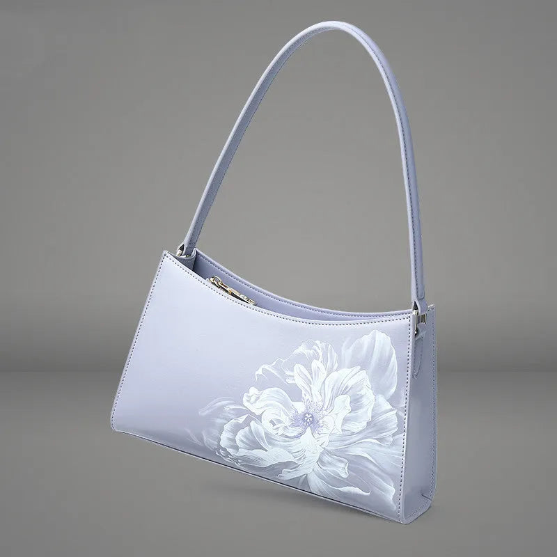 Light purple cowhide leather handbag with zipper closure, compact size for everyday use