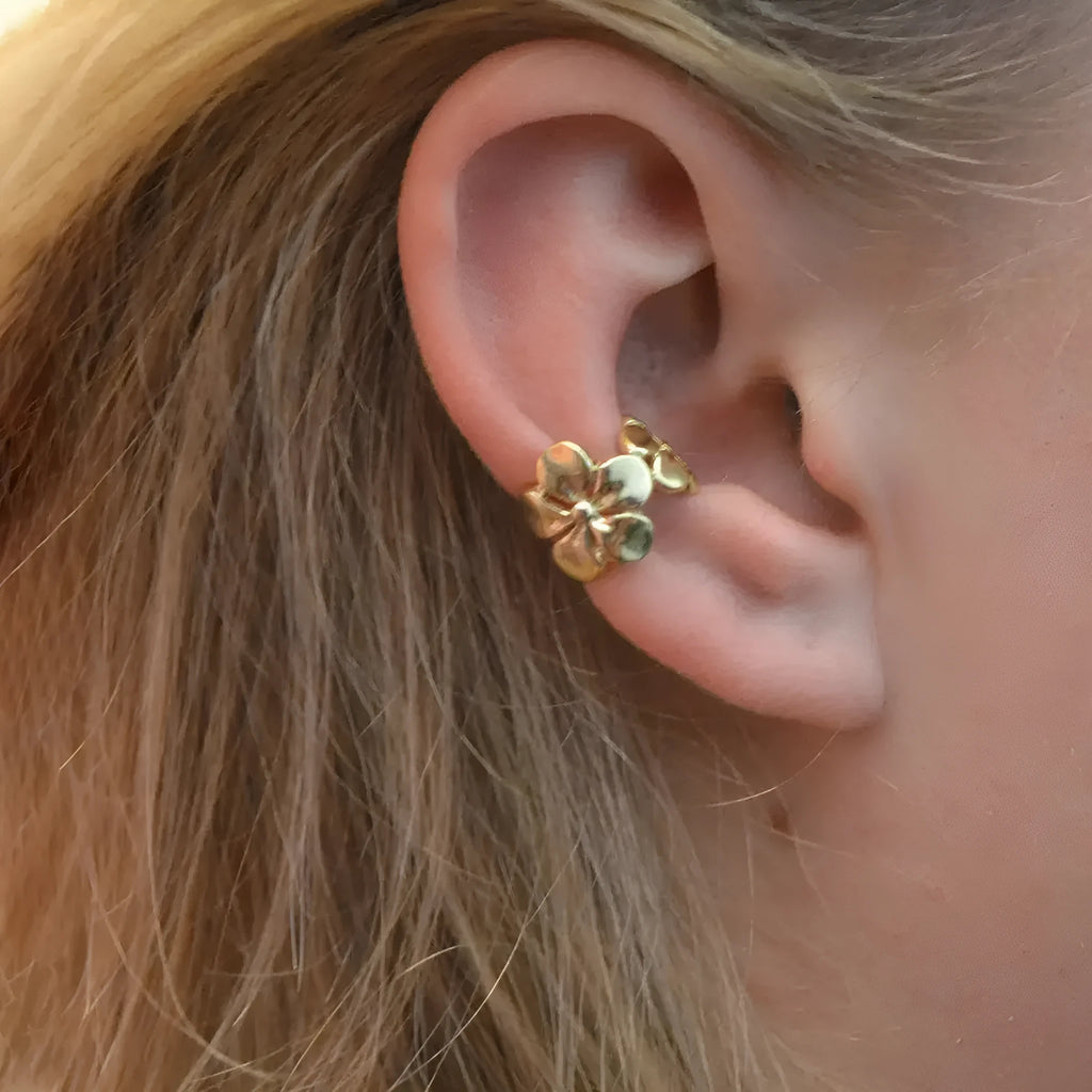 Women's gold alloy earrings with starfish and conch beach elements on post fittings