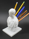 White synthetic resin pen holder designed as an American-style creative character model on a desk.