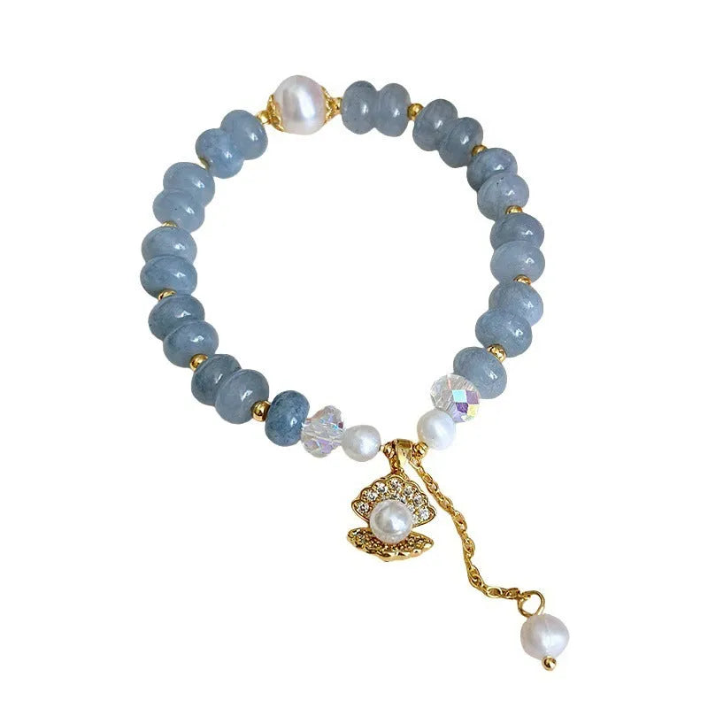 Handmade bracelet with a natural blue-green aquamarine pearl shell on an adjustable band.