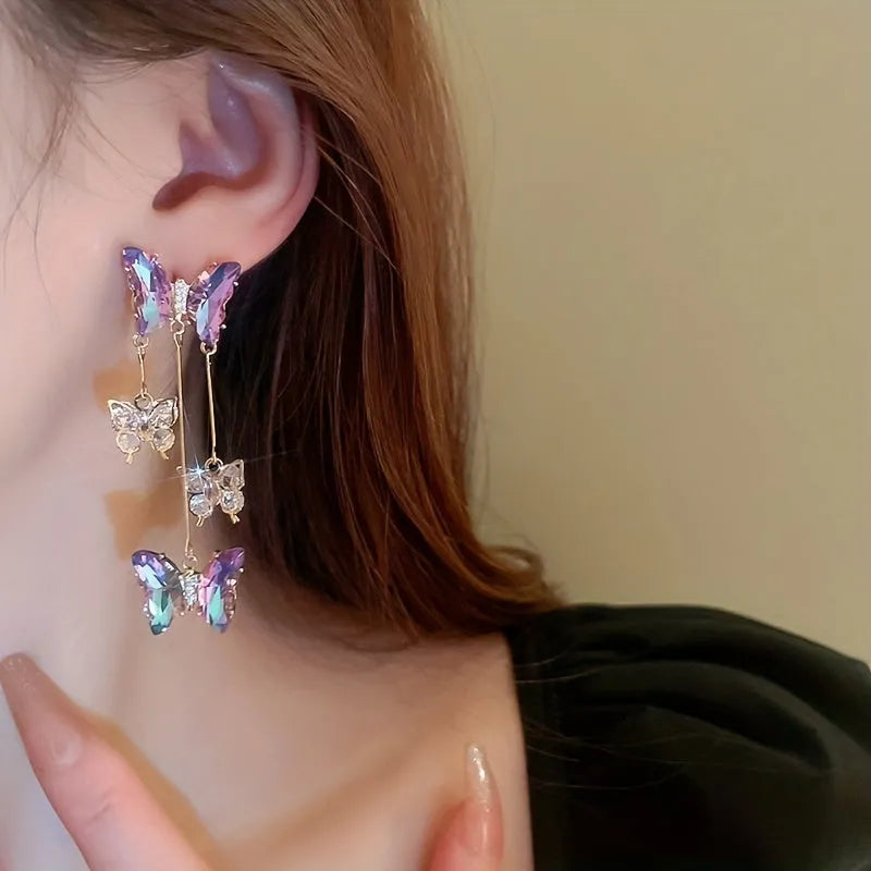 A pair of silver needle blue purple butterfly tassel earrings with crystal flowers on an alloy base.