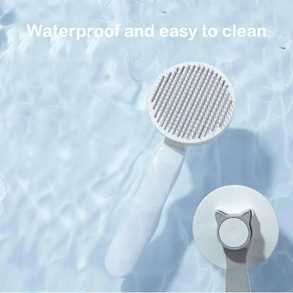 Blue self-cleaning cat grooming brush with rubber-tipped metal pins and ergonomic rubber handle