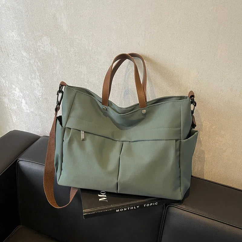 Nylon crossbody tote bag for women in black, shown with crossbody strap.