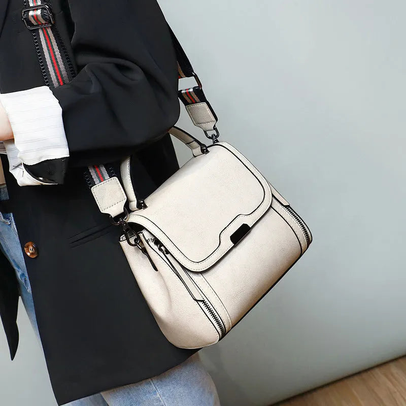 Women's brown genuine leather messenger bag with shoulder strap and internal pockets