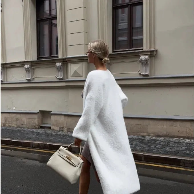 White knit cardigan jacket with extended length on hanger