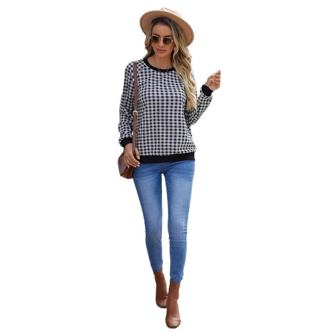 Black long sleeve pullover sweater with a striped plaid pattern, showing regular sleeve cut.