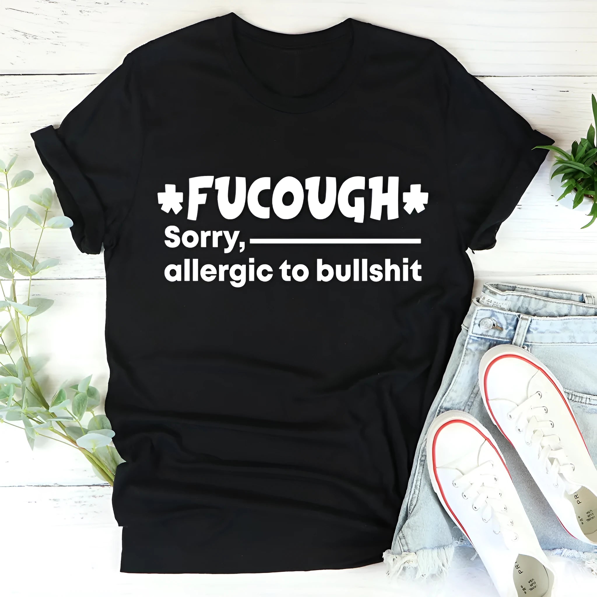 Black unisex cotton T-shirt with round neck and loose short sleeves laid flat.