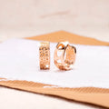 Rose gold women's earrings with three hollowed-out heart shapes in circular pattern