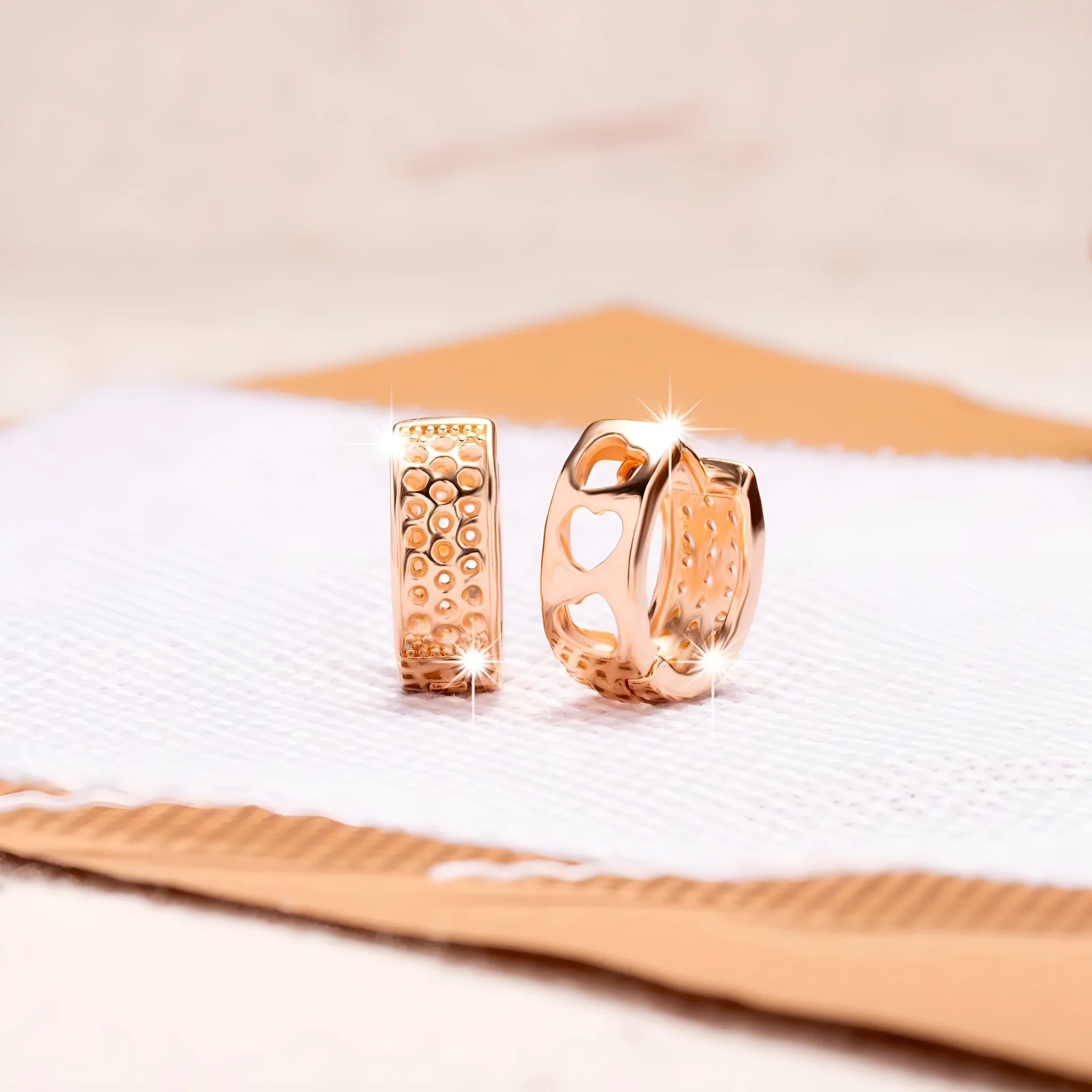 Rose gold women's earrings with three hollowed-out heart shapes in circular pattern