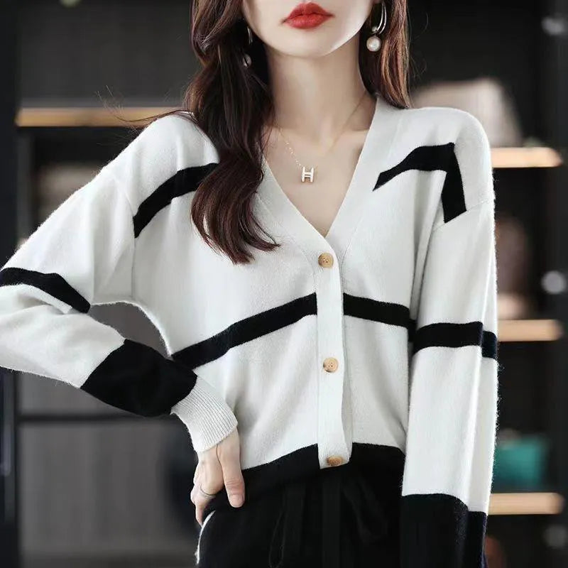 Women's striped V-neck knitted cardigan buttoned up, showcasing its slim fit and 3D pattern texture.