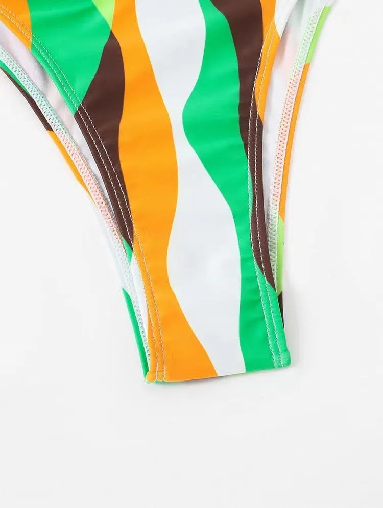 Women's three-piece bikini set with swimsuit top, briefs, and matching printed beach skirt in polyester fabric