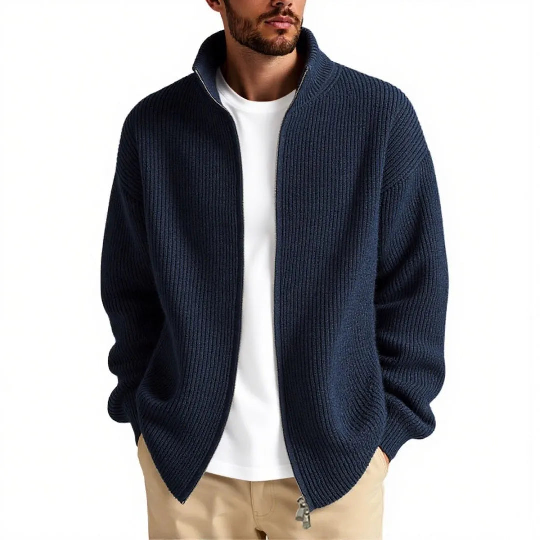 Man wearing a loose-fit grey cardigan sweater coat, showing the relaxed silhouette and knit texture.