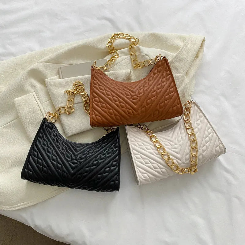 Brown pleated PU leather women's baguette shoulder bag with a chain strap and soft carry handle.