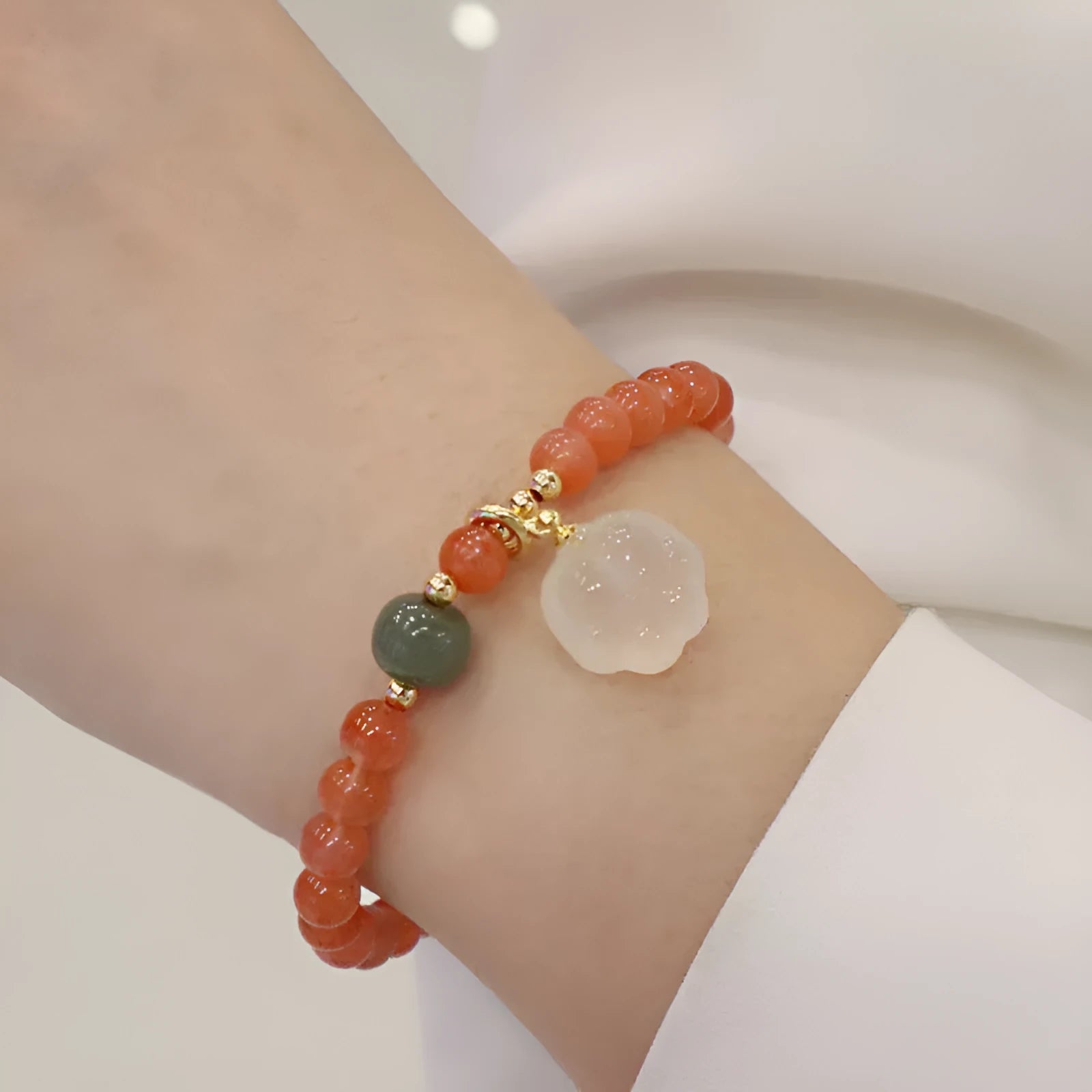 Women's natural red agate bracelet with 8mm cat's paw charms and complementary jade bracelet