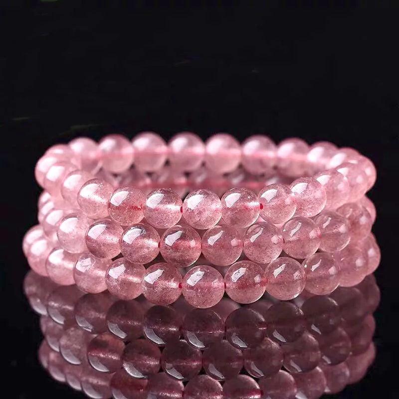 Women's strawberry quartz bracelet with polished beads in 6mm, 8mm, or 10mm sizes on adjustable knot.