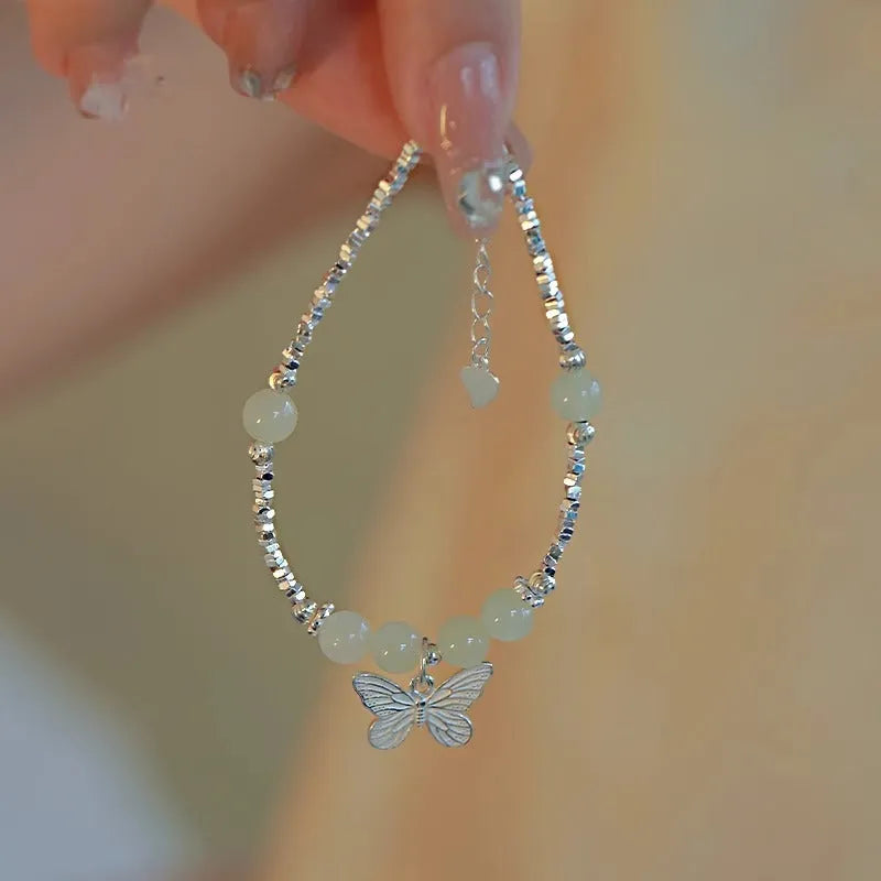 Silver butterfly jewellery set with hetian jade accents showing bracelet and necklace combination