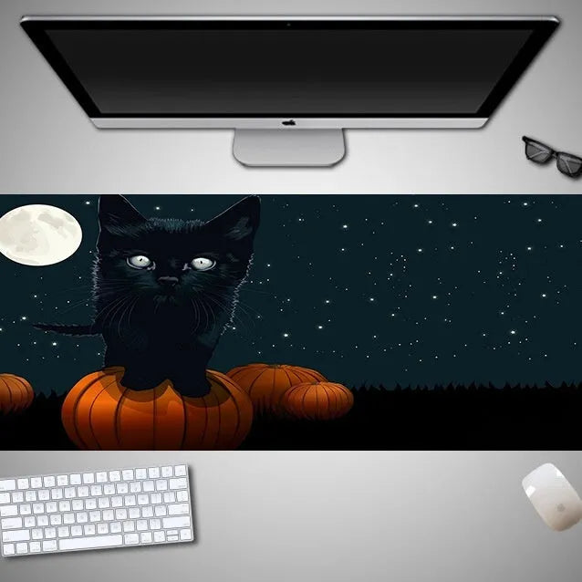 Oversized Halloween-themed mouse pad with non-slip rubber base on a desk.