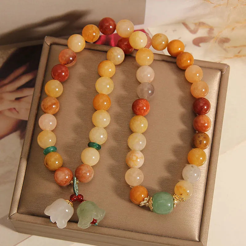 Natural jade multi-layer bracelet for women with an orchid pendant on an adjustable fastening.