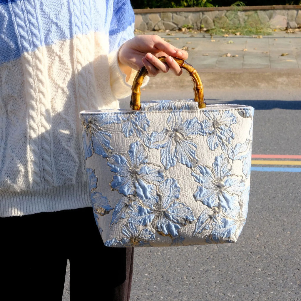 Women's light blue canvas bag with bronzing flower detailing and double shoulder straps