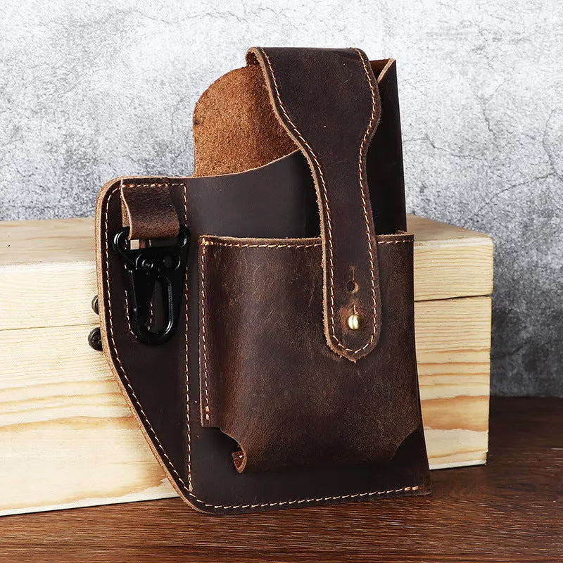 Men's brown leather belt bag with car stitching, shown attached to a belt with phone inside.