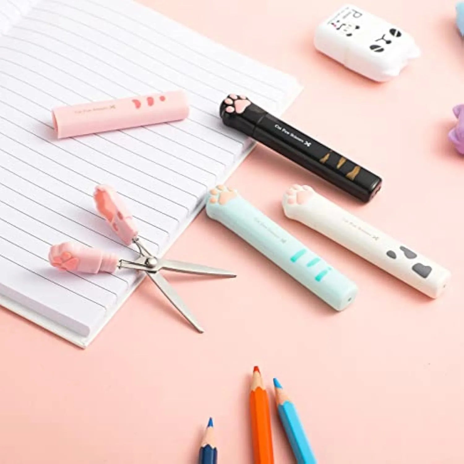 Cat paw design mini folding scissors in pink, showing stainless steel blades and compact size.