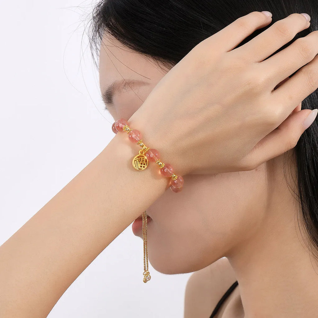 Women's strawberry quartz crystal bracelet with geometric design and fu character element