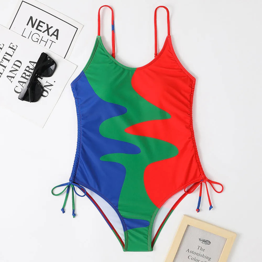 Women's sleeveless one-piece swimsuit in blue, shown from the front, with a backless design and striped pattern.