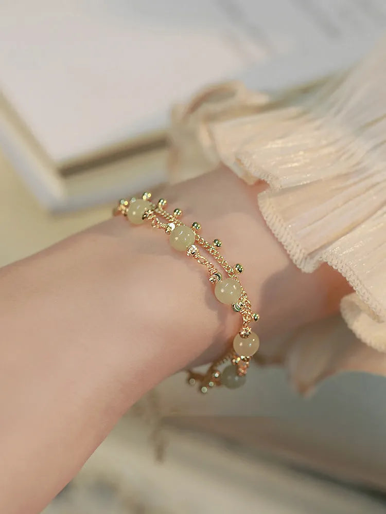 Handcrafted natural Hetian jade bracelet showing bead and charm style variations
