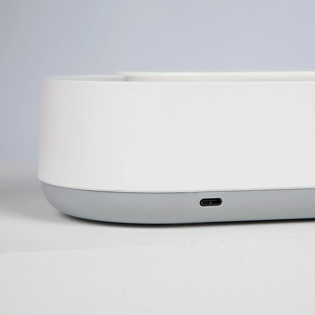 White portable ultrasonic cleaner with stainless steel tank and touch button.