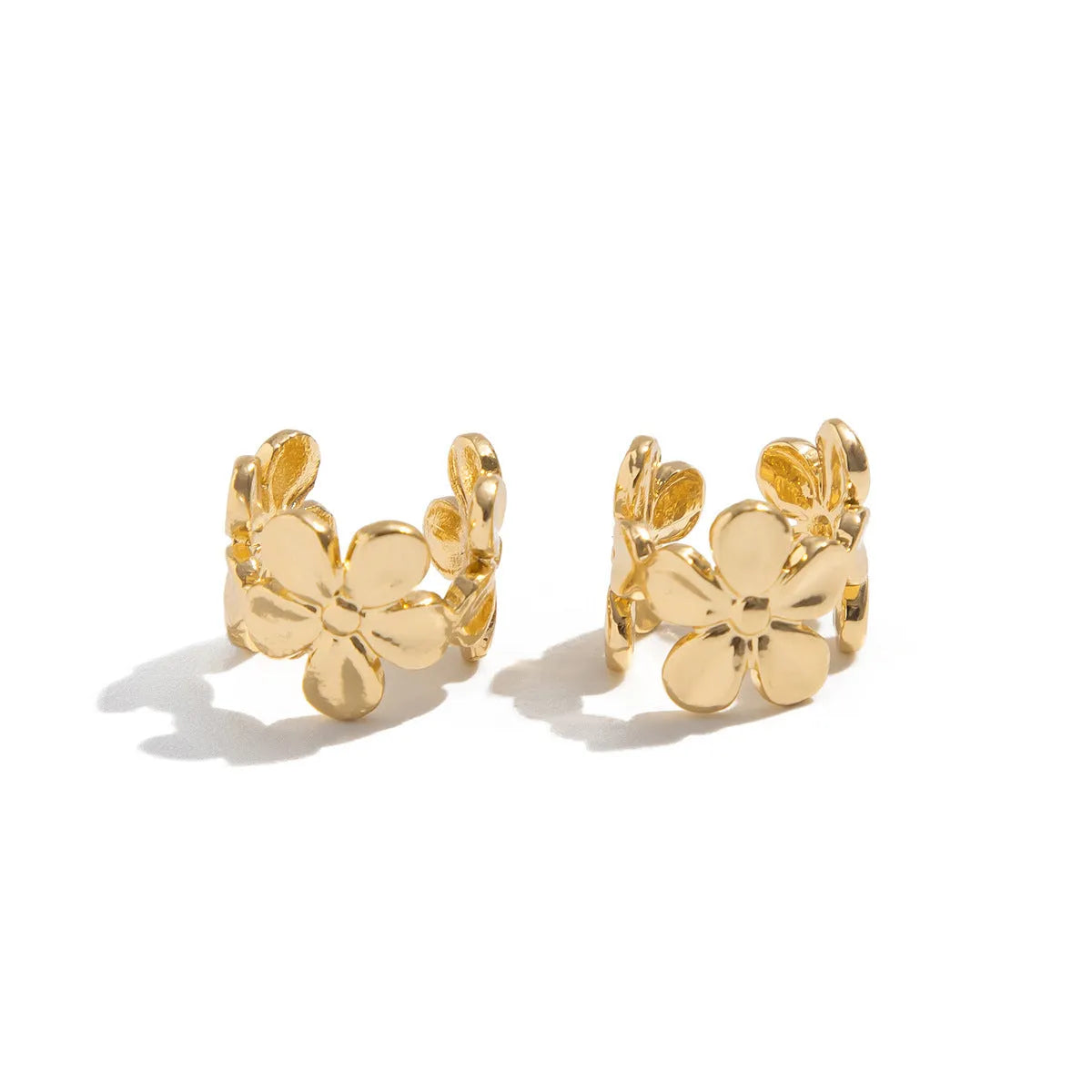 Women's gold alloy earrings with starfish and conch beach elements on post fittings