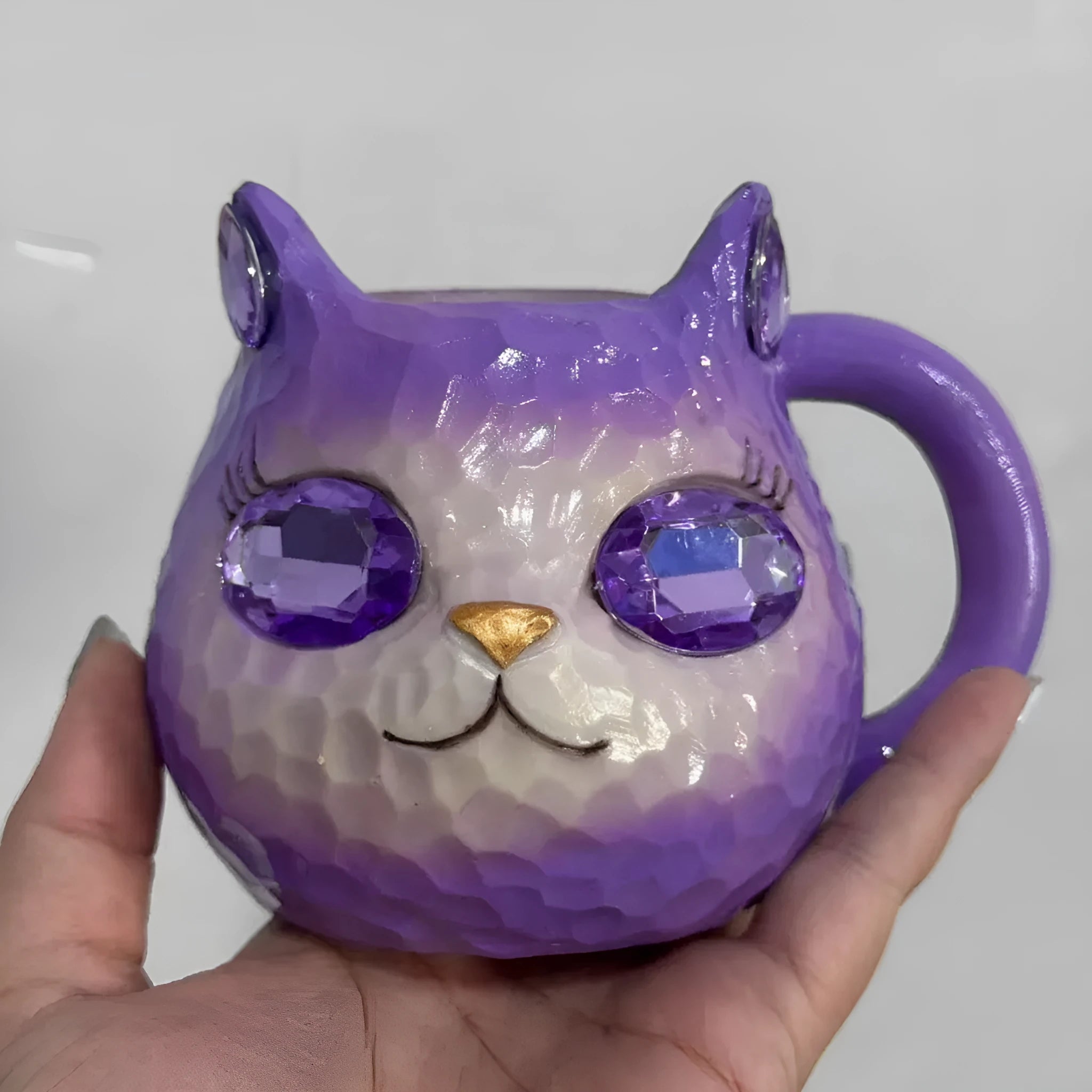 Colourful resin Crystal Earth Cat Cup craft decorative gift on a table.