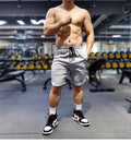 Men's black quick-drying nylon sports running shorts on a grey background.