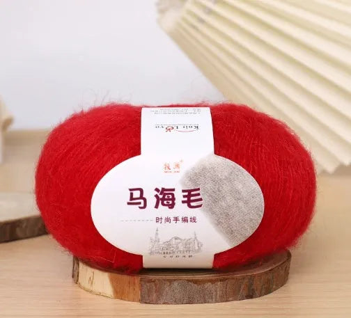 Ball of mohair wool for DIY scarf knitting kit in one of 34 colours including blue, pink, green, grey, and black.