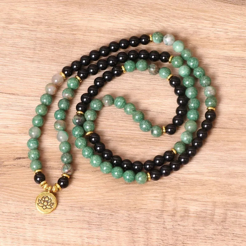 Green and black alloy elastic beaded bracelet with natural styling on wrist
