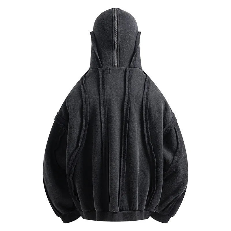Man wearing a loose black zip-up hooded coat with a padded lining.