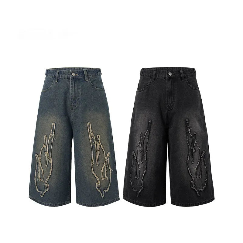 Men's black cropped denim shorts with patch flame embroidery on leg