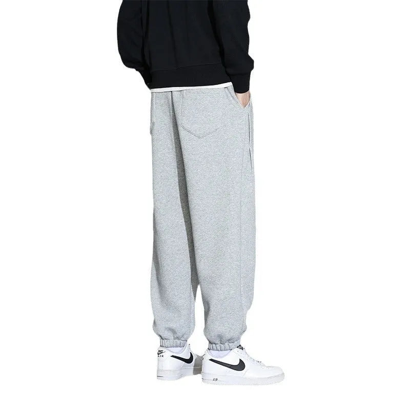 Men's loose fit grey cotton sports trousers with elastic waistband and drawstring closure