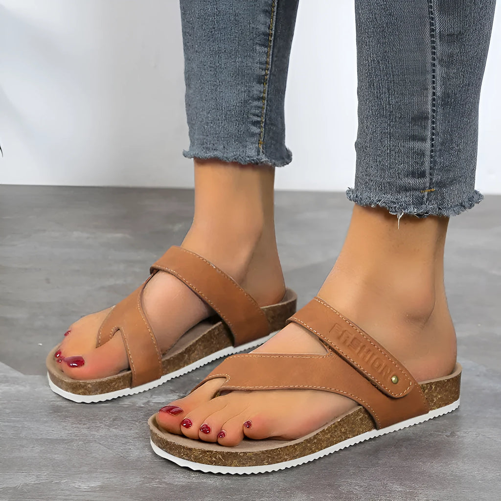 Blue thick-soled flip-flops with a flat toe ring on a light background